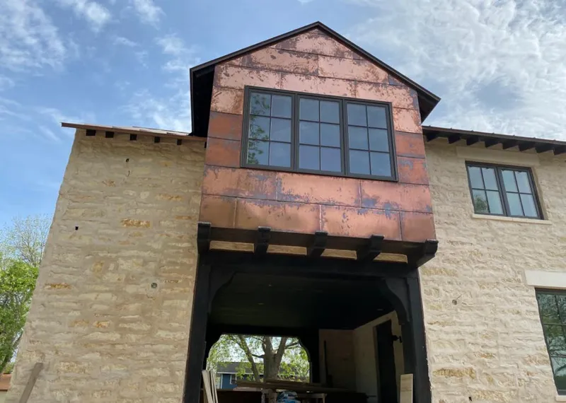 Copper metal panel facade on a stone building for Metal Roof Coating in Orono